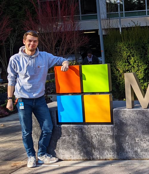 Rory Claasen standing by the Microsoft sign at the Microsoft HQ in Redmond